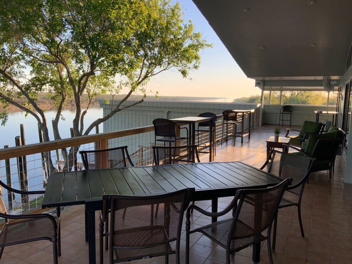 Waterfront deck seating as the sun sets over the arroyo