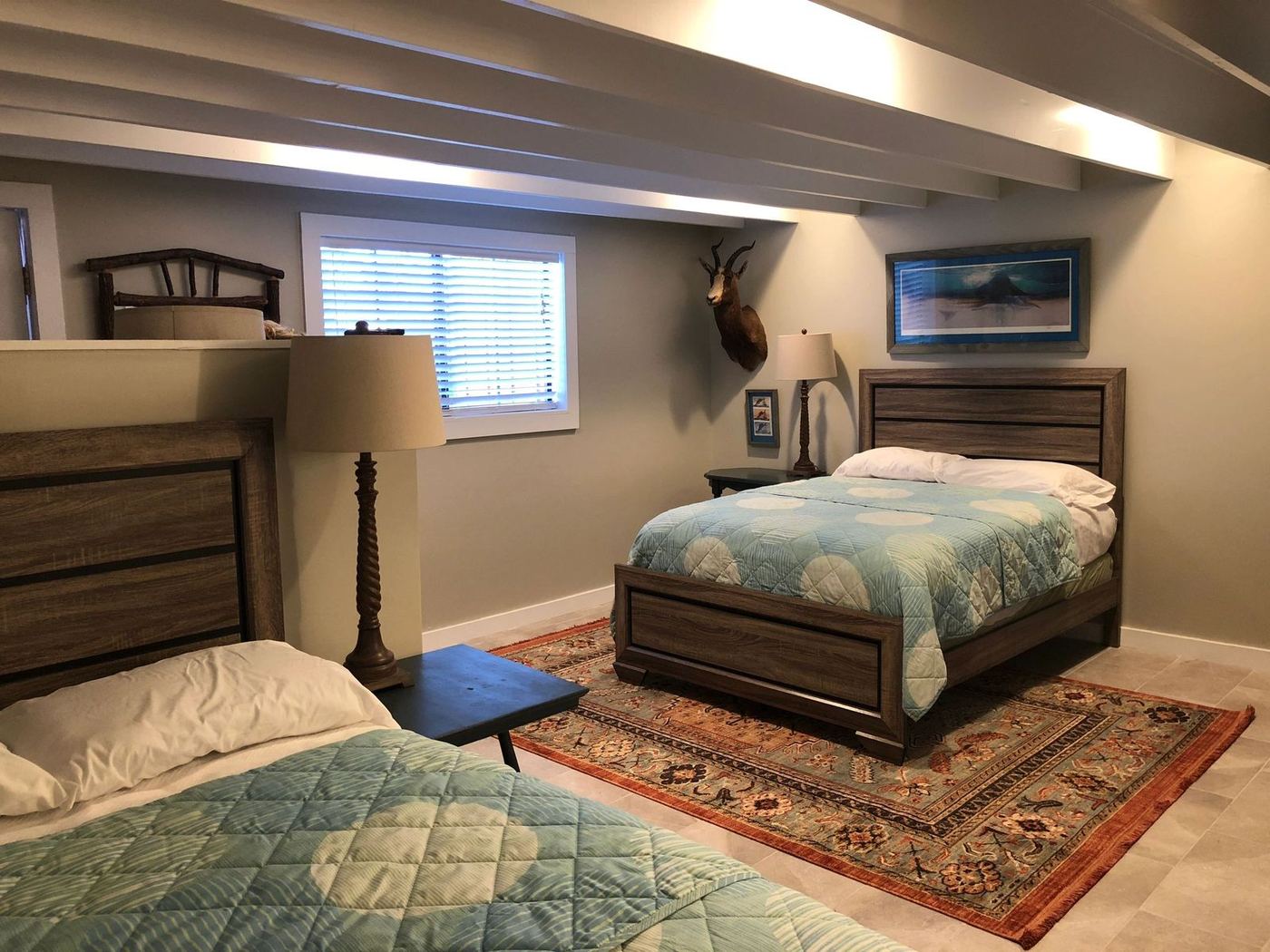 The Casita — bedroom with an aoudad mount above the bed