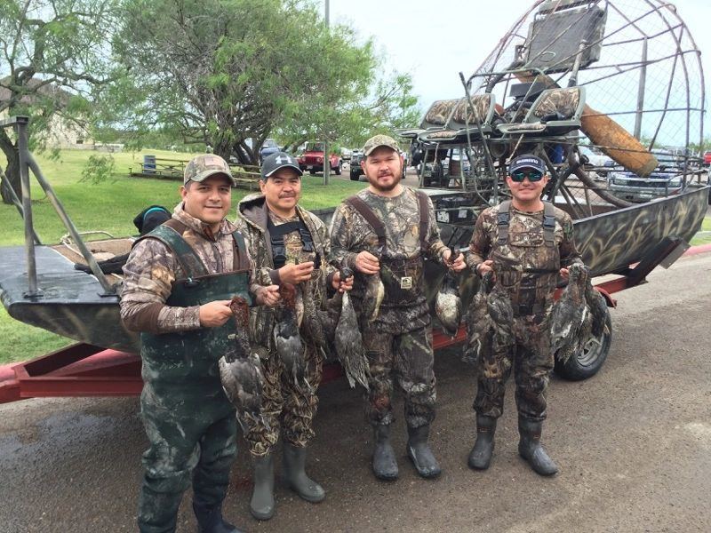 Waterfowl hunters with their ducks alongside the airboat