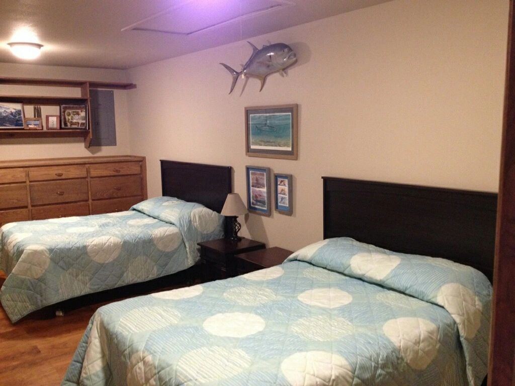 First Floor — twin-bed guest room with permit and sporting prints