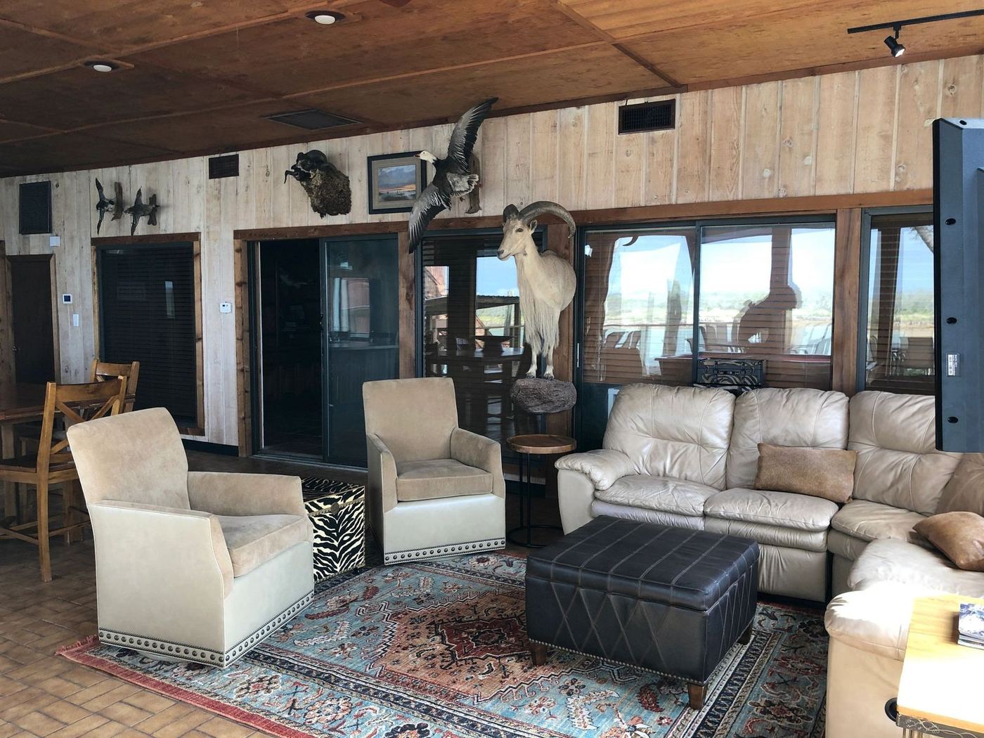 First Floor — lounge seating off the game room with doors to the deck