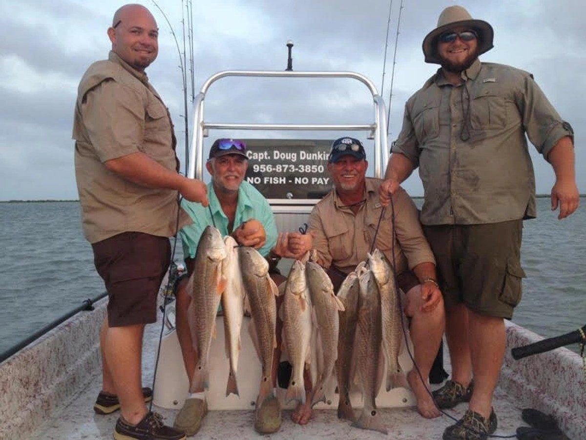 Guests and guides with a stringer of trout